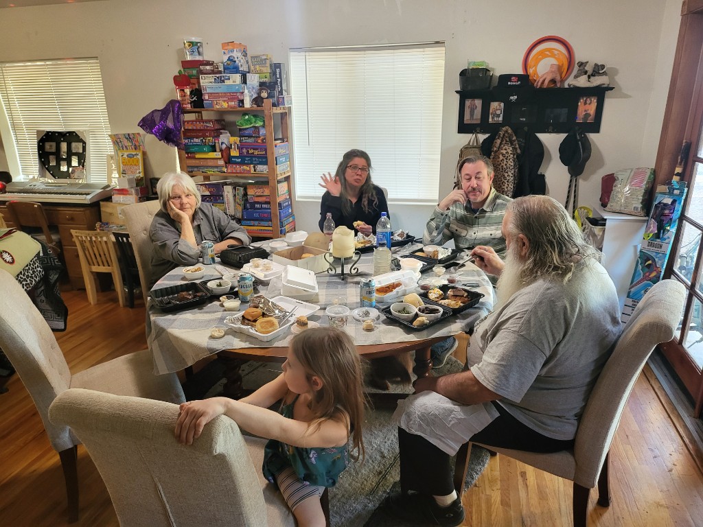 Papaw, Mamaw, James, and Heartley around the dinner table