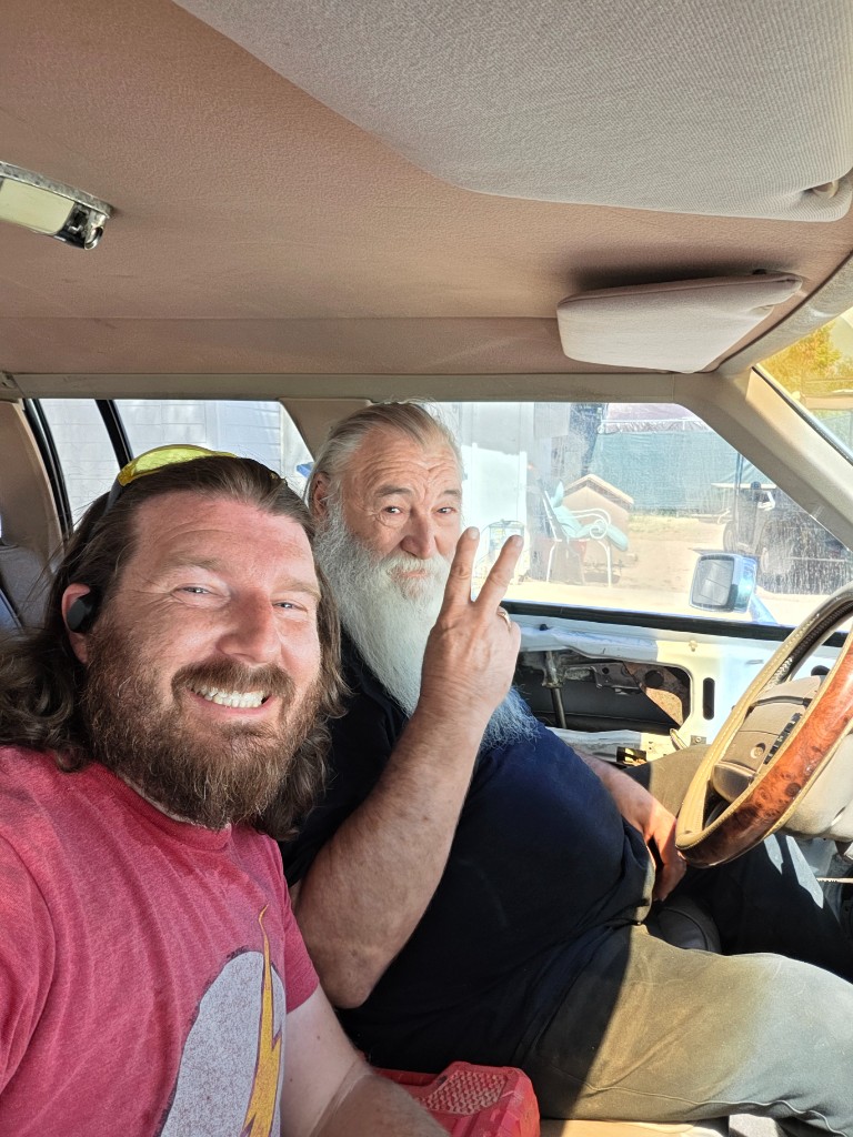 James and Papaw in the car — peace sign
