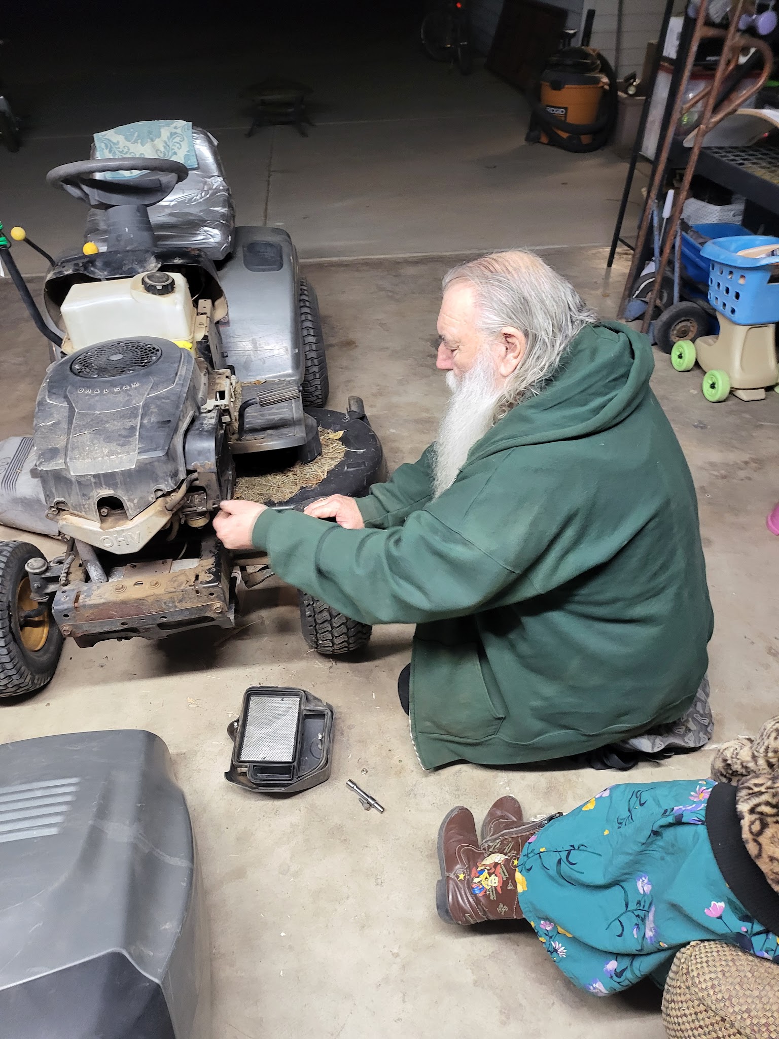 Papaw working on the mower with Heartley nearby